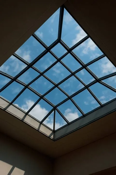 Pyramid glass skylight with dark aluminium framing, seen from below